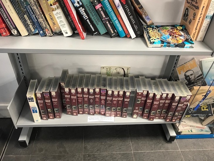 A shelf crammed with Inspector Morse VHS cassettes with maroon covers
