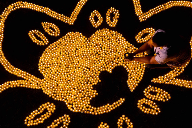 an overhead of the lights, with Beth Namara cappuing a single tea light