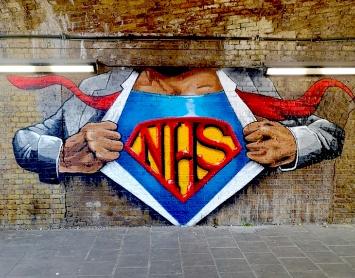A bit of street art with Superman ripping open his shirt to reveal an NHS logo