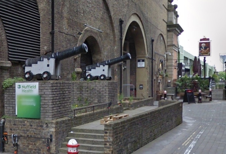 A pair of cannons on a brick wall