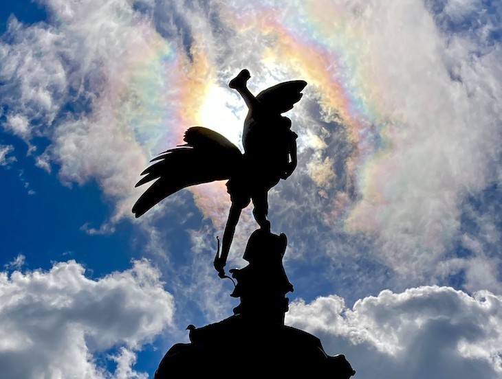 Eros with sun behind and a blue sky. 