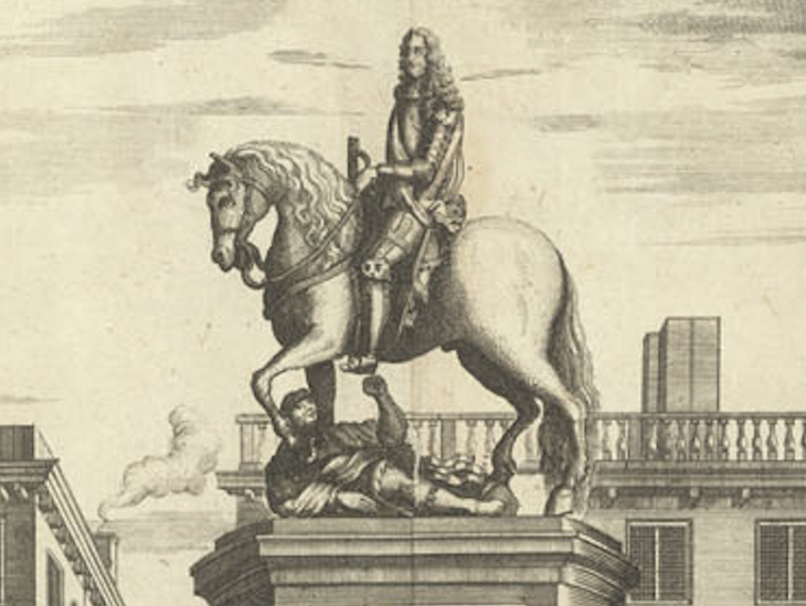 Close up of a statue of a king on a horse, trampling on a prone figure