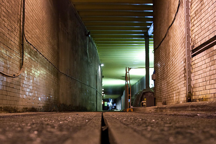 A green-lit square tunnel. We're at track level