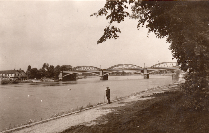 A triple-arched bridge across a river, in black and white