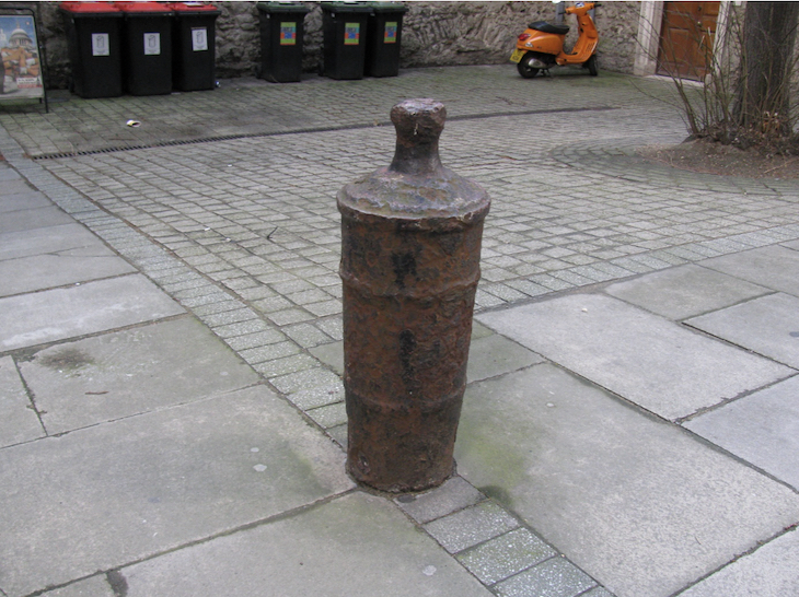 A really, really ancient bollard that's probably just an upturned cannon