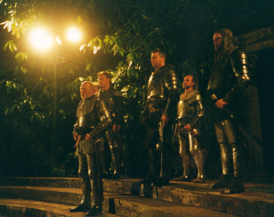 Actors dressed like knights standing tall in a production of Henry VI, Part 1.