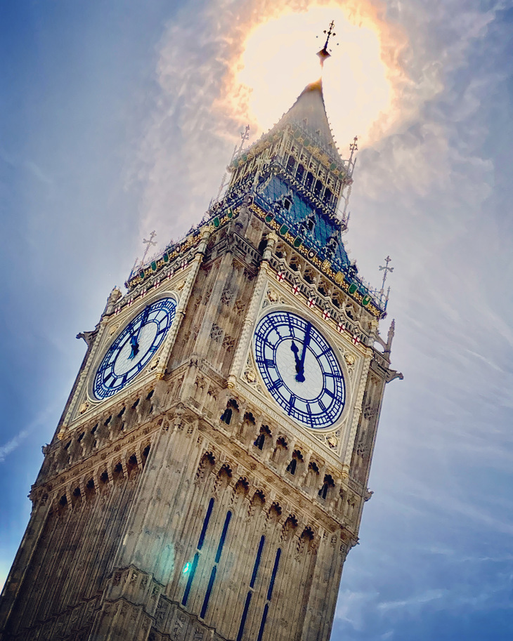 The clockface of Big Ben with brilliant sunshine behind it