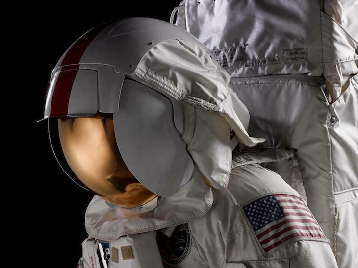 An astronaut dressed in a space suit with a mirrored helmet