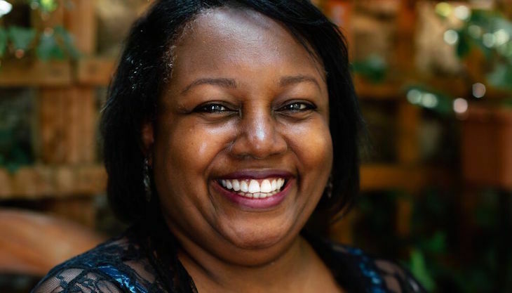 A close-up shot of Malorie Blackman's face, smiling at the camera