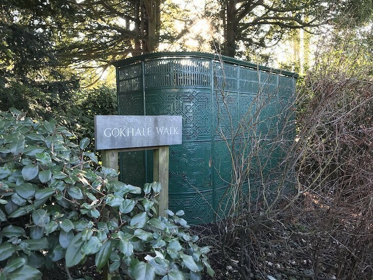 An old Victorian green metal urinal in some shrubbery