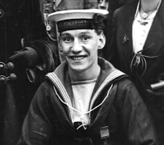 A smiling sailor in black and white