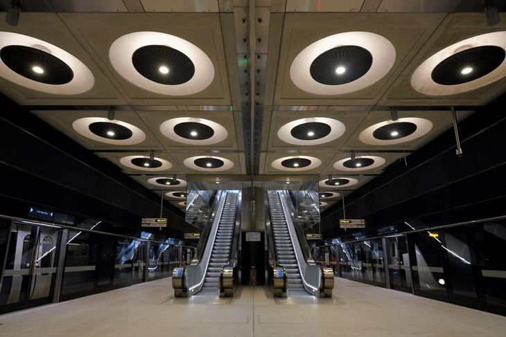 Huge lights that look like whatever Daleks are made of, above a set of escalators