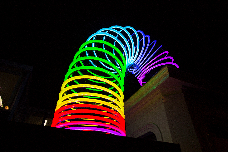 A giant rainbow slinky, illuminated multicoloured in the dark