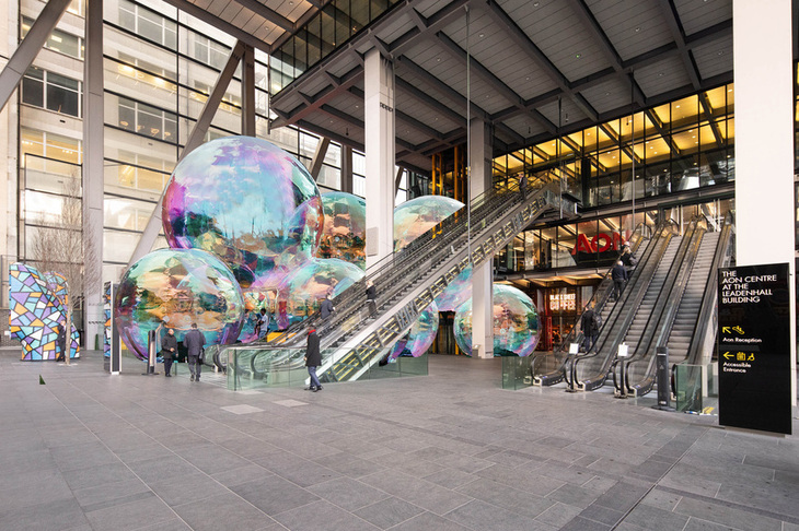 Giant bubbles at the foot of an escalator into a skyscraper