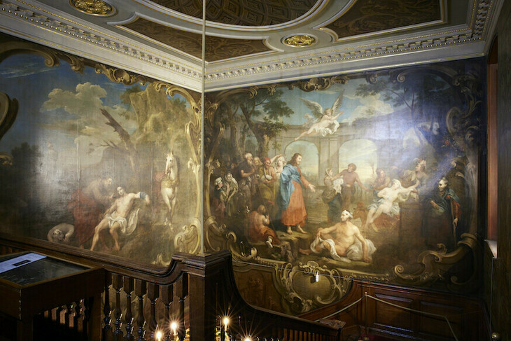 A stunningly painted staircase with various figures with various maladies