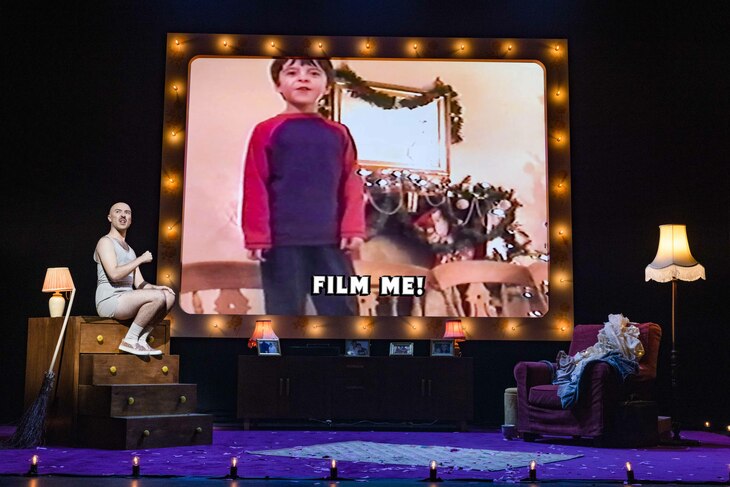 Rob Madge displaying their younger self from an old home video during My Son's a Queer (But What Can You Do?)