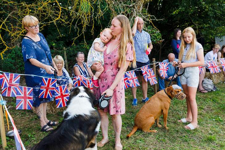 Things to do this weekend in London: a Martin Parr photograph of a family at an outdoor celebration with Union Jack bunting