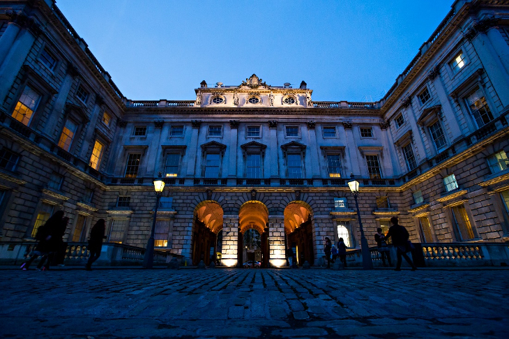 The exterior of the Courtauld Gallery, a neo-classical building at Somerset House, at dusk.