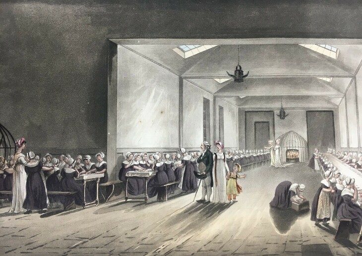 A dining room full of young people dressed in black gowns and white bonnets