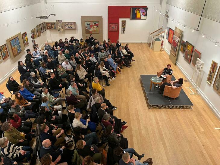 A crowd of people watching a talk