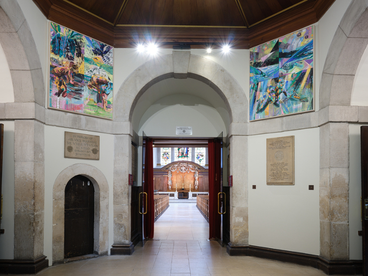 Two colourful panels at the entrance to a church