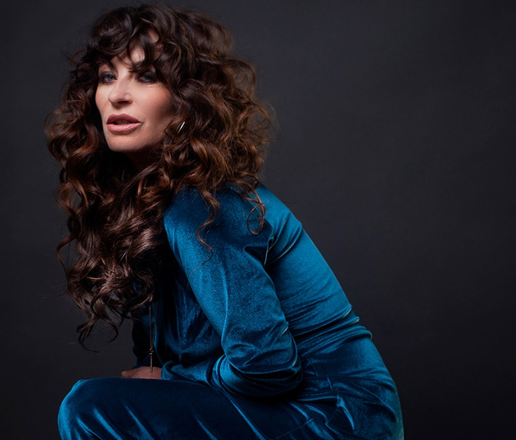 Collette Cooper, wearing a blue velvet dress