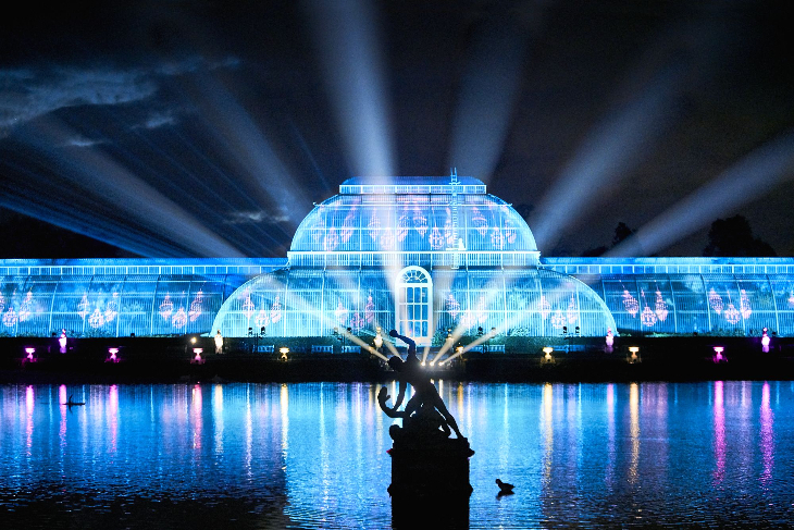 Christmas light festivals London: blue lasers over the conservatory and lake at Christmas at Kew.