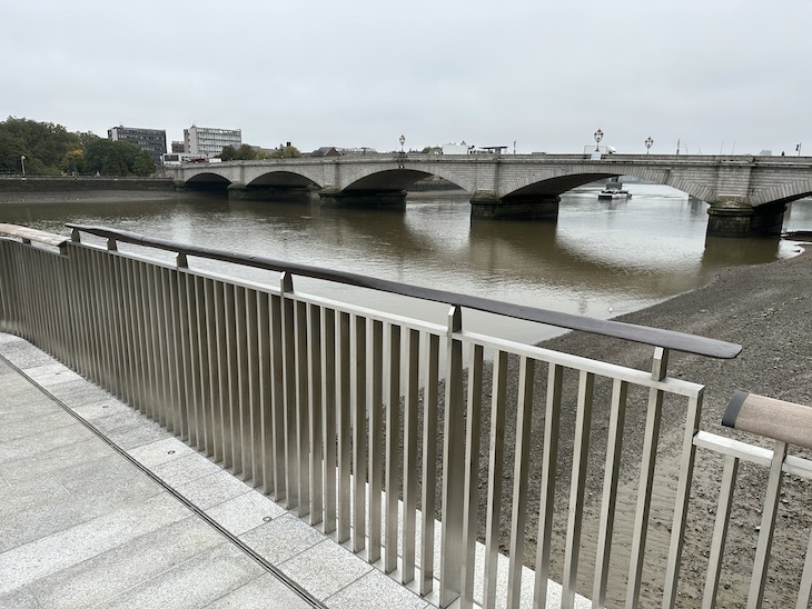 A view of Putney Bridge with the thames and an oar-shaped handrail