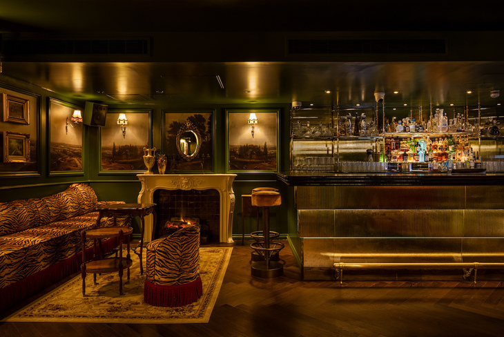 A plush looking cocktail bar with tiger print sofas
