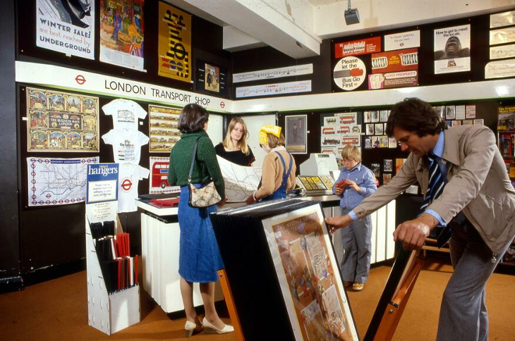 People perusing transport themed merch in a shop in the 80s