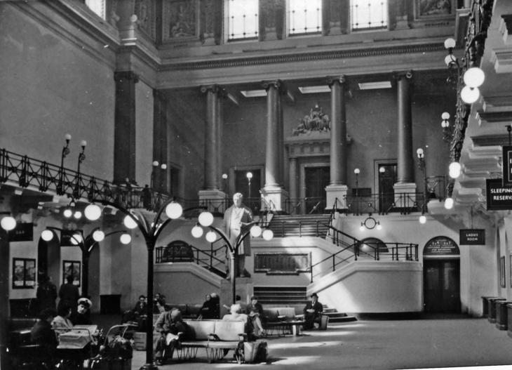 A grand waiting rom with a statue in the middle