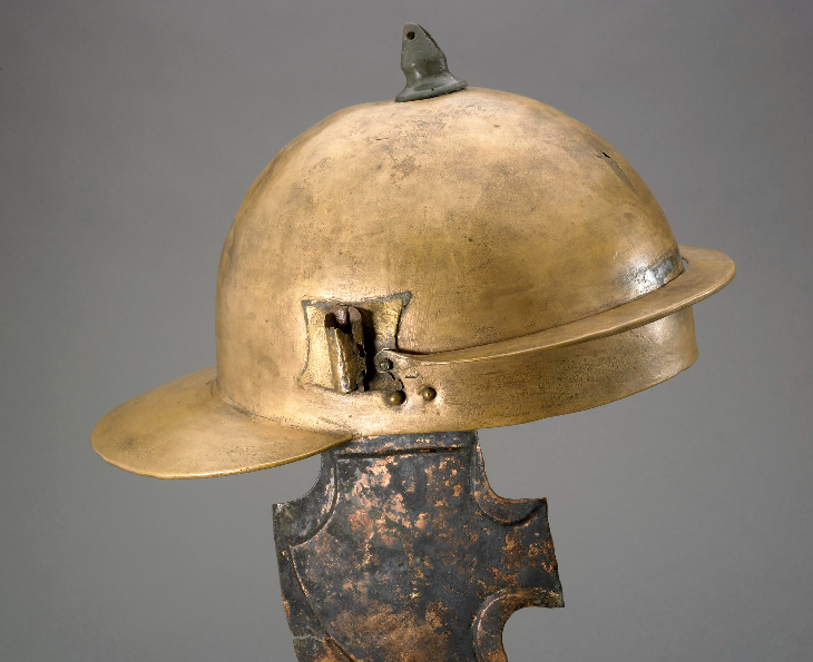A gold coloured soldier's helmet on display