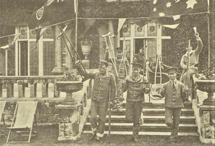 Old photo of soldiers waving crutches aloft