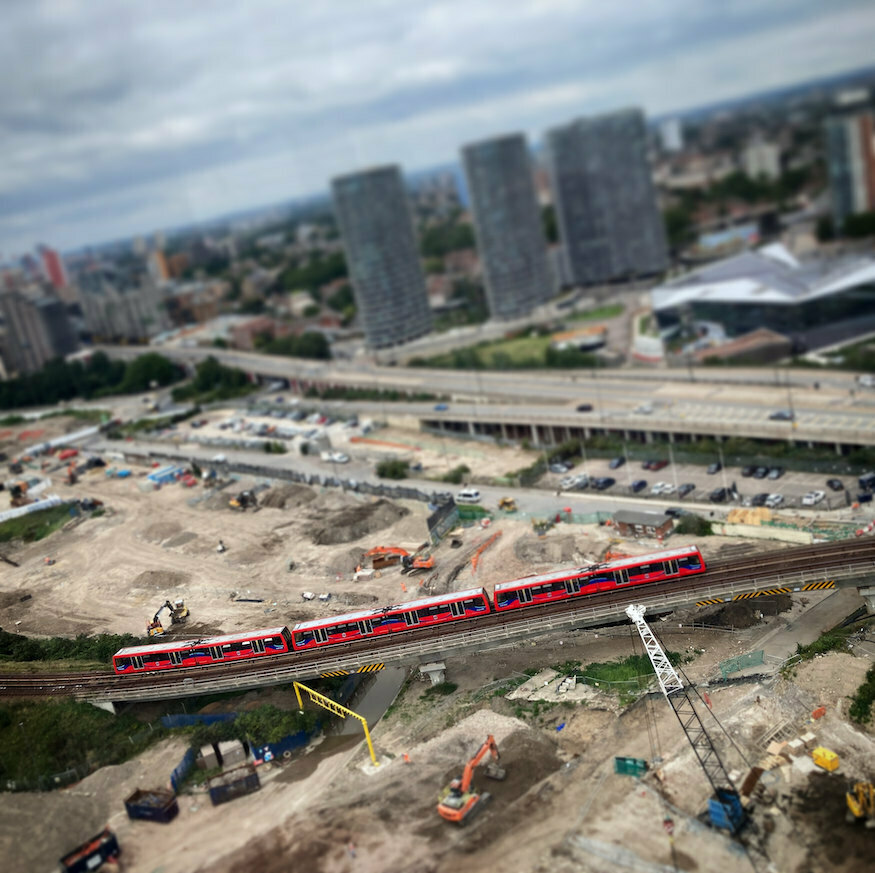 A tilt shift image of the DLR near the royal docks