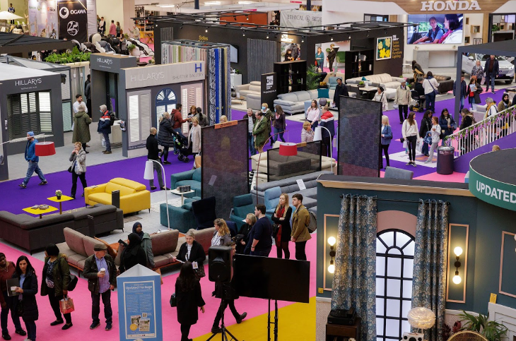 People wandering around various displays at the Ideal Home Show