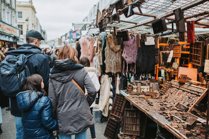 A family perusing a stall at Portobello Road Market