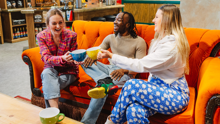 Three friends on the orange Friends couch