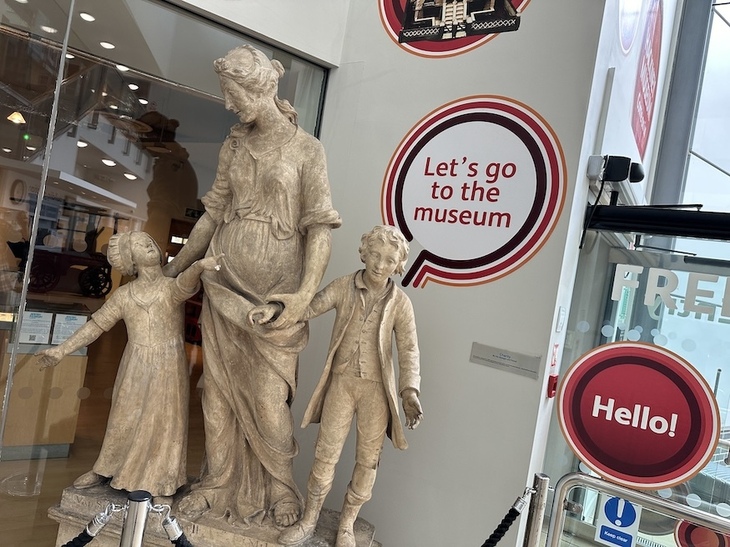 A statue of Charity and two children at Hackney Museum