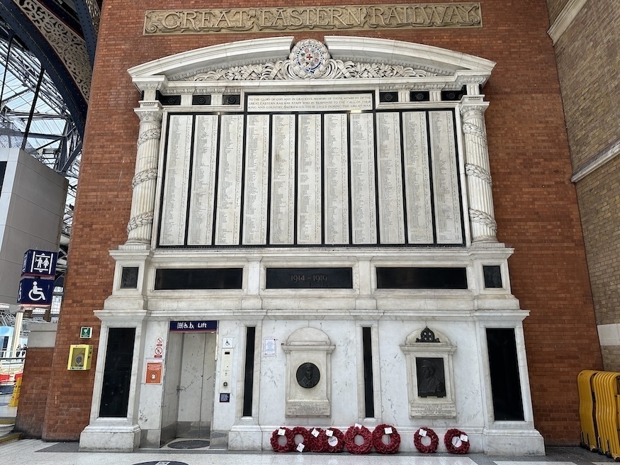 A marble war memorial with a lift in the corner