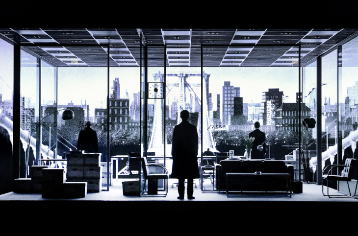 A black and white photograph of cast members on stage during the Lehman Trilogy