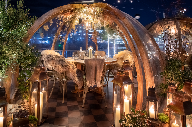 Igloo restaurants London: an igloo furnished with chairs, a table and blankets