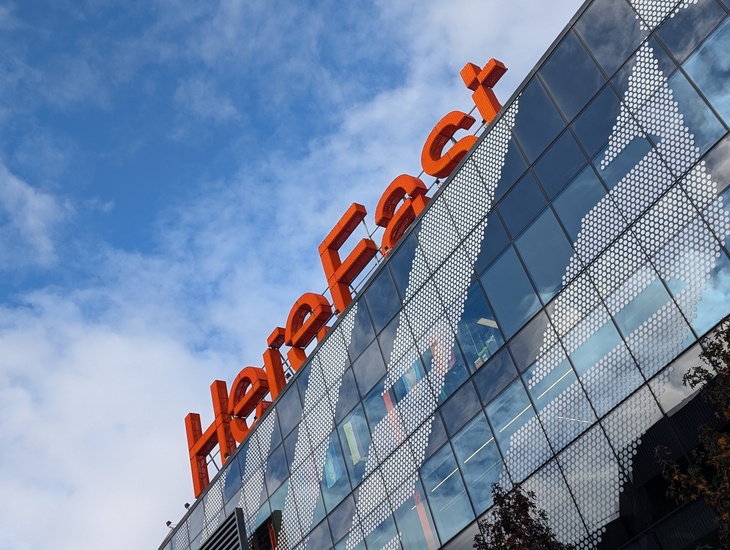 A big orange sign for Here East