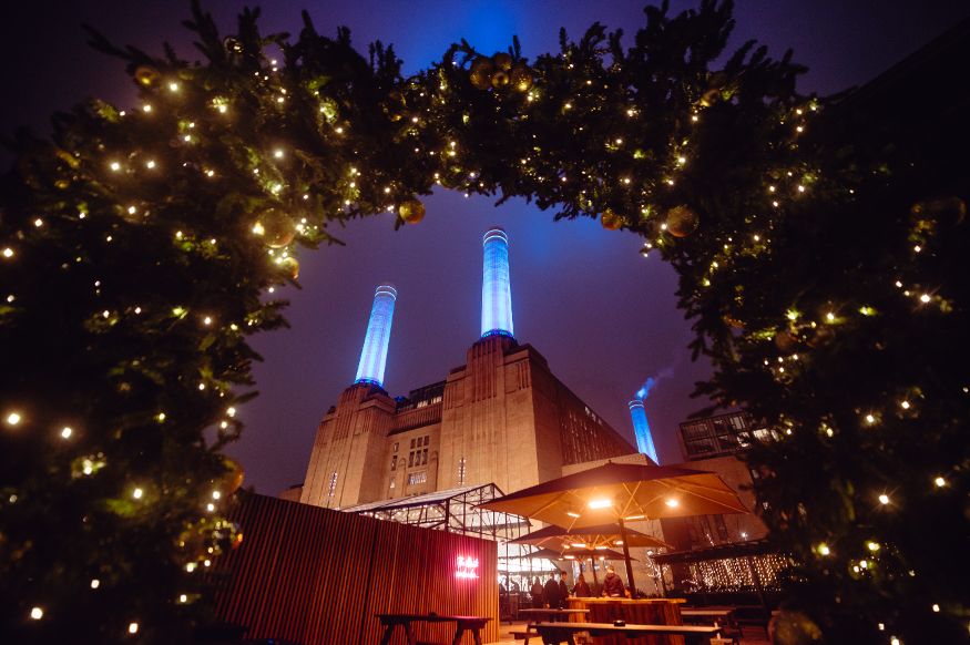 Battersea Power Station, photographed at night through a festive arch