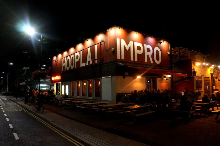 The Best Comedy Clubs in London: A flat roofed pub with Hoopla Impro painted on it