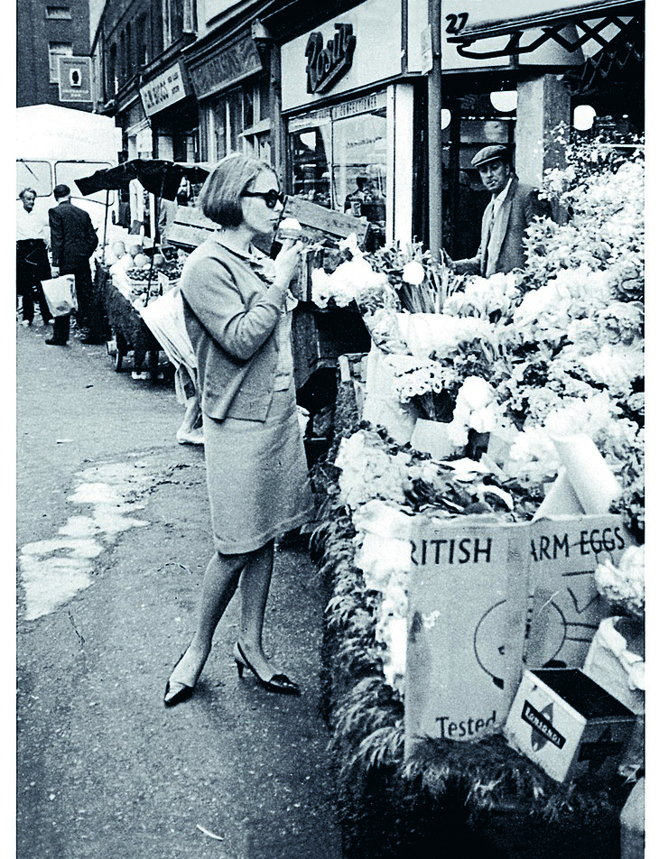 A woman in sunglasses eating an ice cream