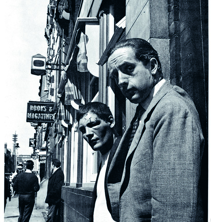 Two tough looking men looking at the camera