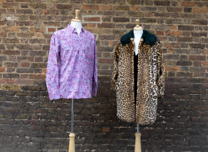 A lilac patterned shirt and leopard print coat on mannequins next to each other