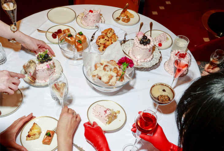 A table filled with plates of small dishes and cakes