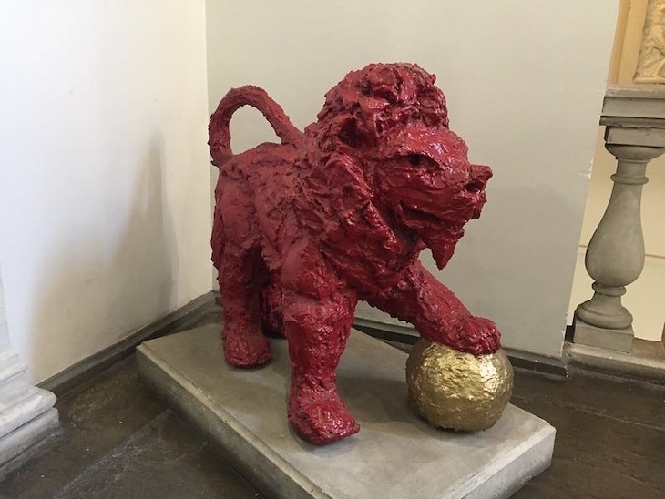 A red lion with golden football