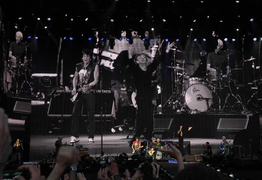 The Rolling Stones playing a gig, projected onto a huge screen behind them